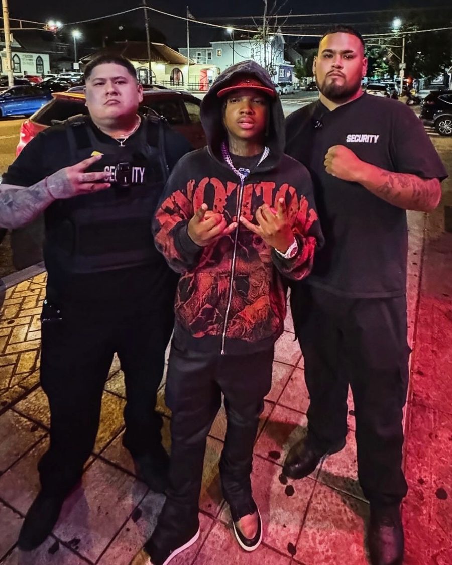 Two TCP security guards with an artist outside a DPX event